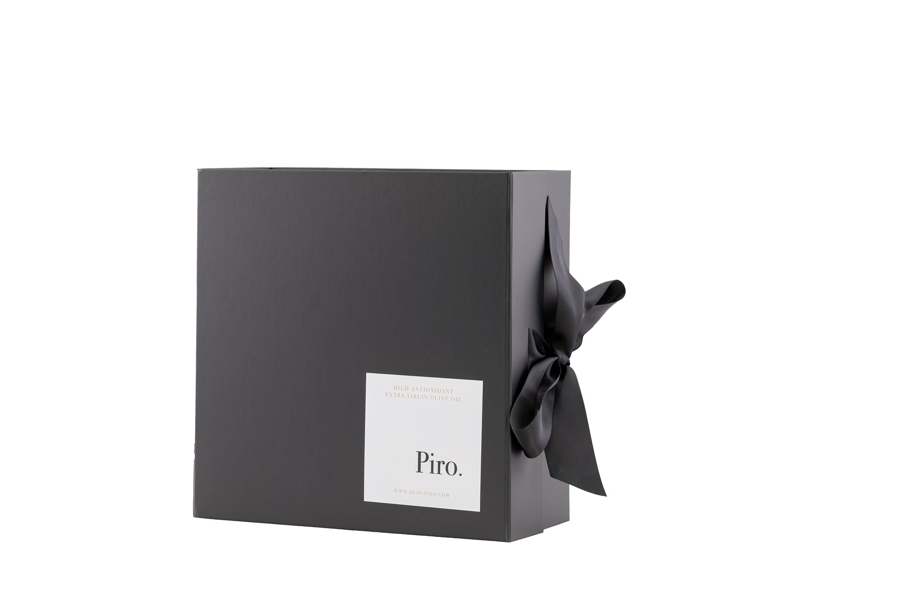 Olio Piro gift box with a white label on the front, adorned with a black ribbon, containing custom selections of Olio Piro and Bonini Balsamic  premium olive oil bottles
